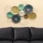 Metal Akoko Round Wall Decor With Clock featuring teal lotus disc motifs and gold accents, large botanical metal wall art by Vedas Homes