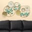 Bossa Leaves Botanical Metal Wall Decor Clock with teal leaves, cream floral accents and Roman numeral clock for living room wall decor