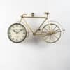Gold Joy Metal Cycle Wall Clock shaped as a vintage bicycle with dial in the front wheel